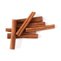 Cinnamon sticks isolated over white background closeup. Canella spice. Aromatic condiment background. Flat lay, top view..