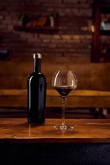 Glass of red wine on table at home