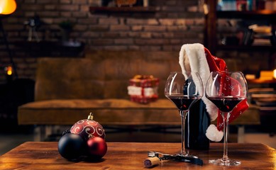 Glasses of red wine on table at home at Christmas