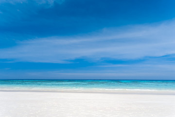 Fototapeta na wymiar White sand beach, clear water, deep blue sky in the tropical sea of ​​Thailand.