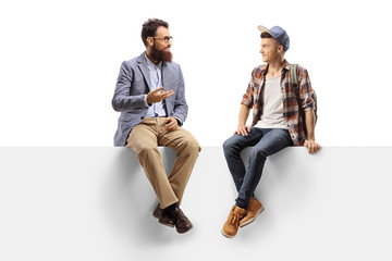 Teacher talking to a male student sitting on a panel