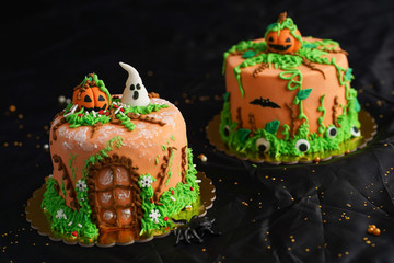  Cakes with Hallowen Party Decorations, made with orange fondant in a dark background, design has...