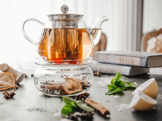 Tea in a glass teapot on the light background