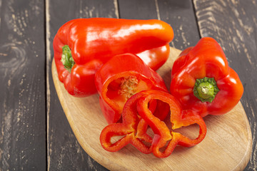 Fresh red peppers on black wooden background