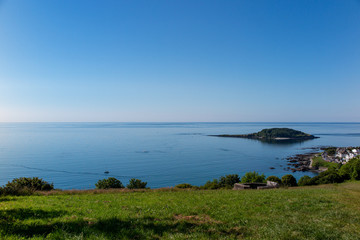 Calm early morning sea at Looe Cornwall with Looe Island