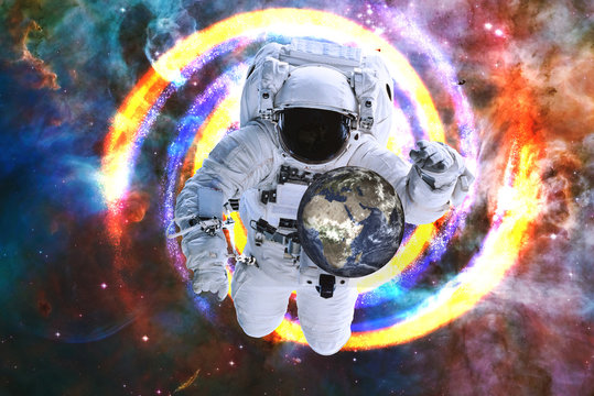 Astronaut save the Earth from crysis in black hole in outer space. Global disaster avoid concept, Elements of this image were furnished by NASA