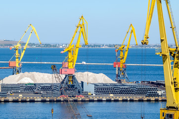 Port cargo crane loads a container onto a cargo ship