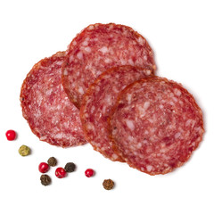 Slices of salami isolated on white background closeup. Sausage top view.