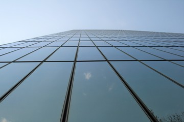 Fototapeta na wymiar sky and clouds reflected in windows of modern building