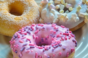 Sweet colorful dessert. Donut with a hole and pink delicious icing.