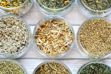 Set of various herbs. Herbal teas in jars on a wooden table.