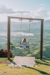 Beautiful view of young woman swing on the top of the mountain Redonda in Dominican Republic. Concept travel, vacation