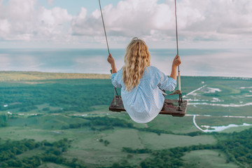 Beautiful view of young woman swing on the top of the mountain Redonda in Dominican Republic. Concept travel, vacation - obrazy, fototapety, plakaty