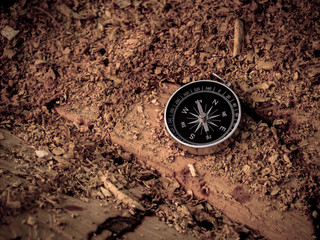 Fototapeta na wymiar Compass on the wooden background in journey.