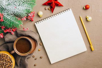 Christmas composition from notebook, pen, coffee cup and fir dranches on wooden background, place for text. Christmas, winter, new year concept. Flat lay, top view, copy space