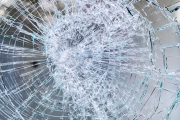 Glass of a broken and cracked commercial showcase.
