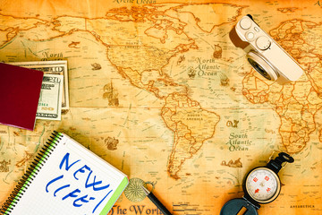 Old paper world map, as a travel background, and accessories for a photographer to work as a digital nomad.
