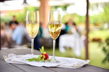 Pair of champagne glasses on a tray to celebrate the love of a couple.