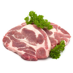 Raw pork neck chop meat with parsley herb leaves garnish isolated on white background cutout