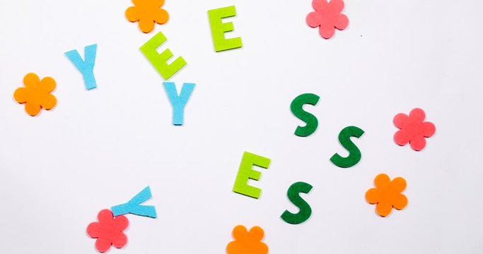 the word yes is written in dancing letters