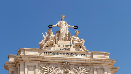 Obraz premium Allegorical sculpture atop the Arco da Rua Augusta overlooking the Praça do Comércio in Baixa, Lisbon City Centre.