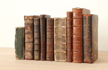 vintage books on wooden shelf.