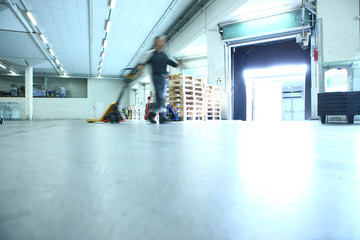 Workers in a warehouse loading up a car