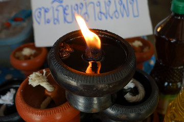 Burning oil lamps in the Thailand temple.
