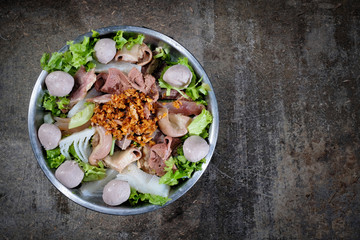 Thai style beef in a hotpot with vegetable on wood background