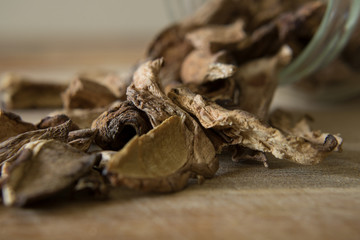 Close-up photography of dried porcini mushrooms and a glass jar