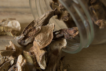 Close-up photography of dried porcini mushrooms and a glass jar