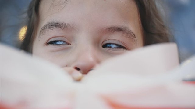 Interesting video of pretty kid stealing a gift box from under the christmas tree at night.