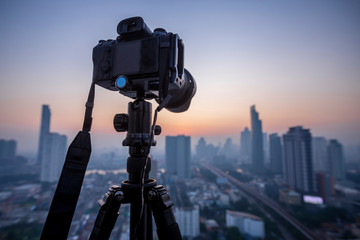 Professional DSLR Mirrorless camera on a tripod,  taking pictures of the beautiful moments during the sunset ,sunrise.