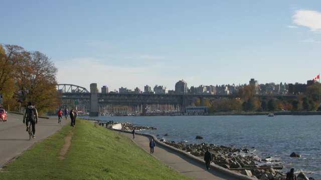 people riding on the english bay seawall