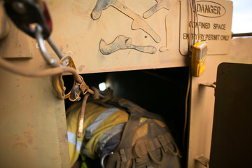 Close up shot of rope access worker wearing safety harness, helmet connecting three two one rescue...