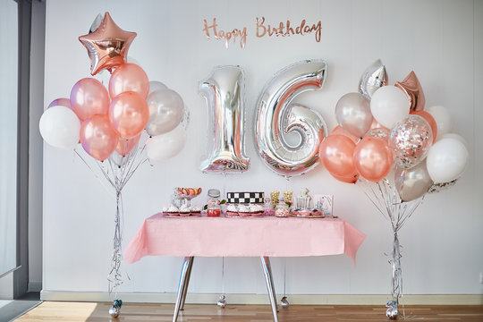 Candy bar and balloons, number 16 from balloons for birthday celebrations