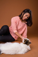 Portrait of beautiful multi ethnic woman with pet cat