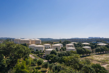 Fototapeta na wymiar Aerial view and skyline view of large storage tanks in urban factory area