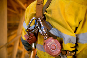 Locking carabiners which attached into red self retracting shock absorber safety device equipment...