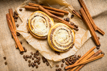Fresh cinnamon buns on the rustic wooden background. Selective focus. Shallow depth of field.