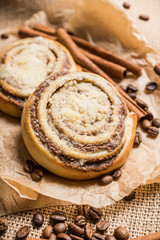 Fresh cinnamon buns on the rustic wooden background. Selective focus. Shallow depth of field.