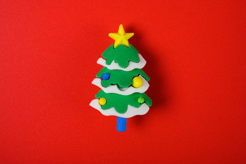 christmas decorative doll of fir tree on red background