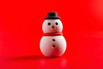 christmas decorative doll of snowman on red background