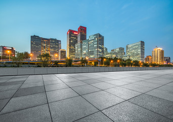 Empty city square road and modern business district office buildings in Beijing at night, China