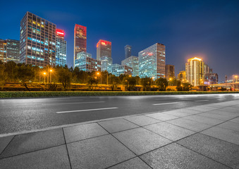 Naklejka premium Asphalt highway and modern business district office buildings in Beijing at night, China