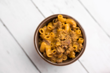 Homemade Cheeseburger Macaroni and cheese served in a small brown bowl made with ground turkey