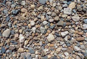 Small gravel close-up. Background and texture of stones on the beach. Gravel path.