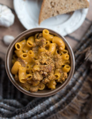 Homemade Cheeseburger Macaroni and cheese served in a small brown bowl made with ground turkey