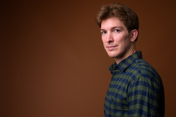 Obraz premium Face of young handsome hipster man in green checkered shirt