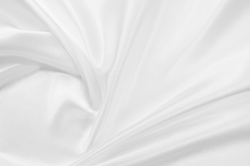 Fototapeta na wymiar Delicate satin draped fabric white texture for festive backgrounds